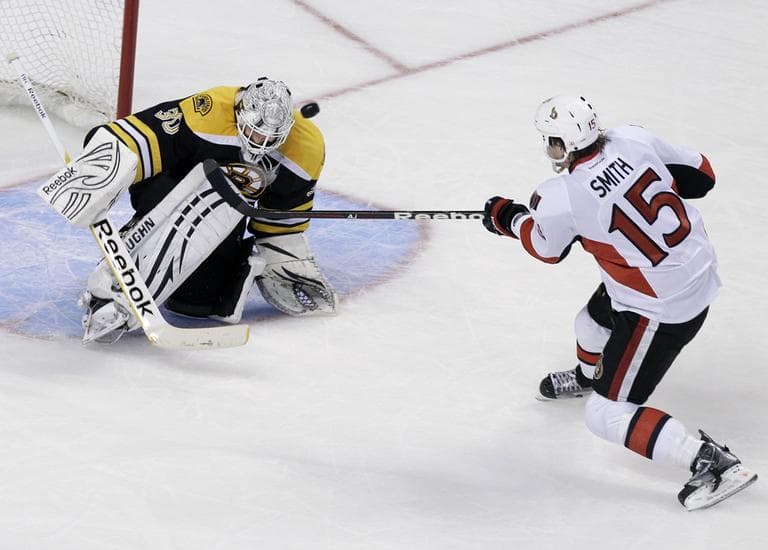 Boston Bruins goalie Tim Thomas makes a save against a shot by Ottawa Senators left wing Zack Smith on a breakaway during the third period of an NHL hockey game in Boston Tuesday. (AP)