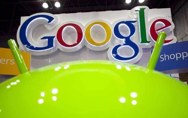 A sign for Google is displayed behind the Google android robot, at the National Retail Federation, in New York. in January. (AP)