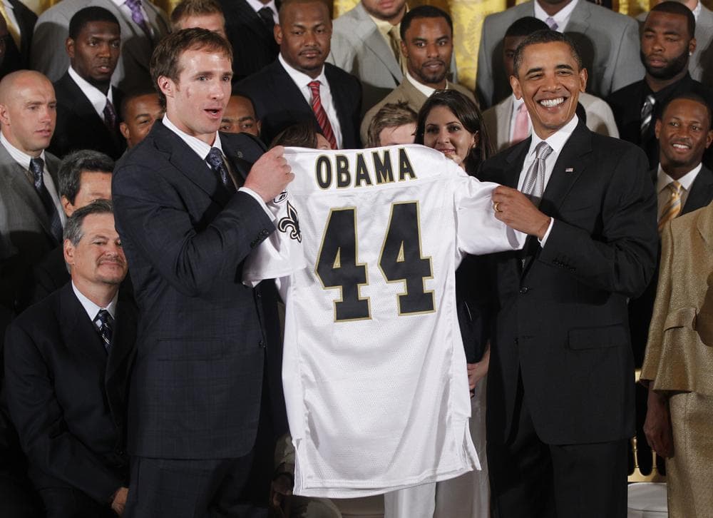 The 2012 NFL season will start a day early to give President Obama (shown here in 2010 with New Orleans quarterback Drew Brees) a night to himself. (AP)