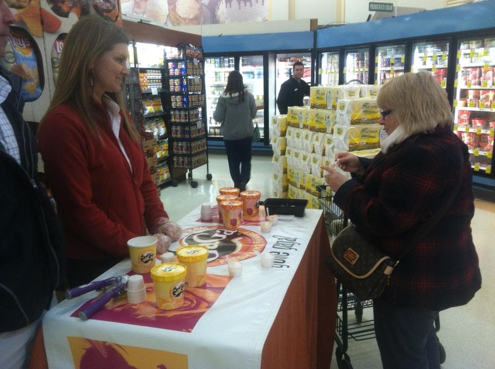 Shoppers try samples of GaGa’s lemon sherbet, and often ask if it's connected to pop singer Lady Gaga. (Curt Nickisch/WBUR)