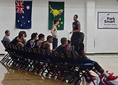 The Gaels squad takes a break during a practice. The Australian flag hangs in the background. (Dan Brekke/Only A Game)