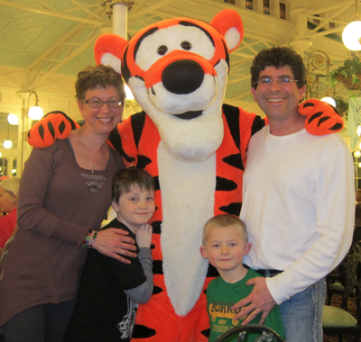 Marie Colantoni Pechet with her husband, sons and Tigger.