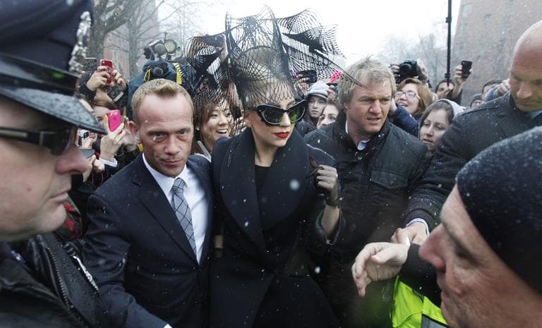 Lady Gaga is surrounded by security as she walks through the campus prior to an event at Harvard University Wednesday Feb. 29. (AP)