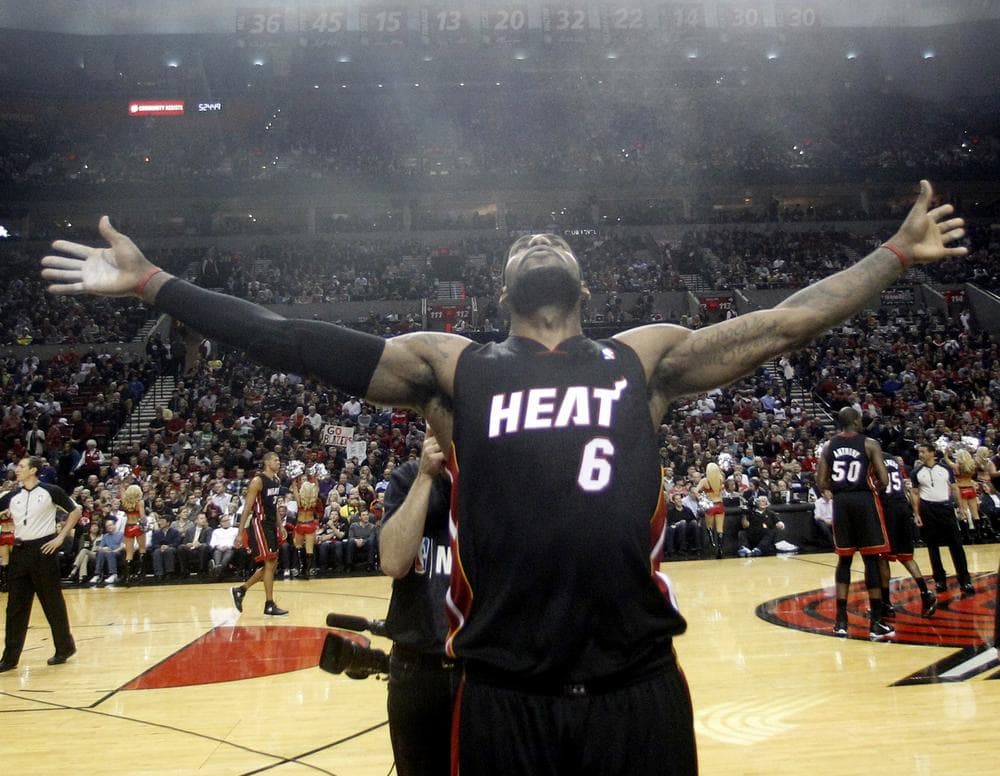 LeBron James throws powder in the air at the start of Thursday's game against the Portland Trail Blazers. LeBron's season has been good, but can it be called the best ever? (AP)