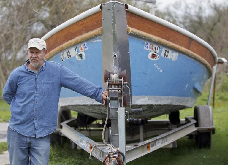 Glen Swift stands by one of his boats in Port Sulphur, La. Swift, a fisherman, said he worked cleanup boats and got sick one day cleaning up a big patch of oil. (Matthew Hinton/AP)