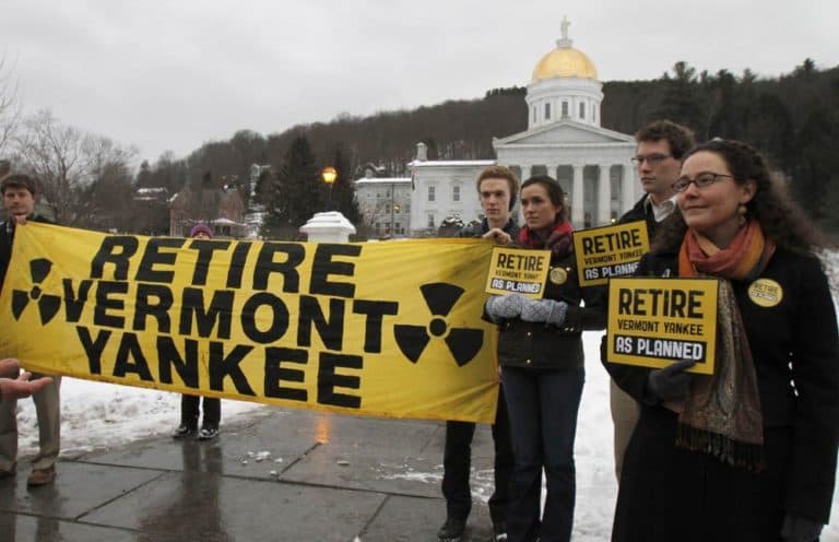 Protestors hold signs during a vigil to support the closing of the Vermont Yankee nuclear power plant at the Statehouse Monday, Jan. 23, 2012 in Montpelier, Vt. (AP)