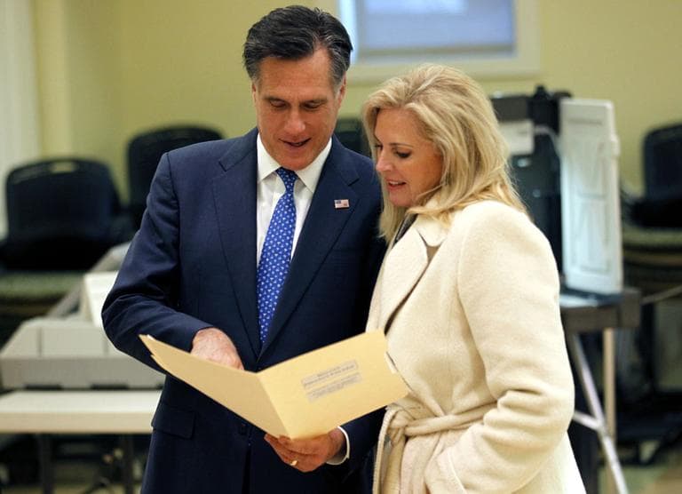 Former Gov. Mitt Romney looks at his ballot with his wife Ann as he votes in the Massachusetts primary at the Beech Street Senior Center in Belmont, Tuesday. (AP)