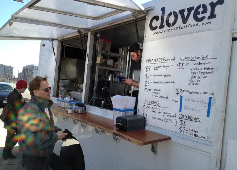 Radio Boston co-host Anthony Brooks orders lunch at the Clover Food Truck on Commonwealth Avenue Wednesday. (Adam Ragusea/WBUR)
