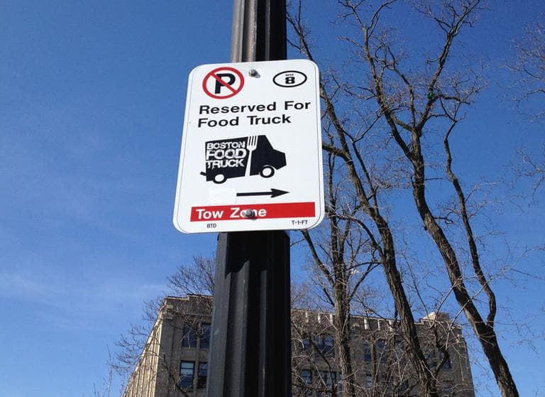 A sign marks a reserved food truck space on Commonwealth Avenue. (Adam Ragusea/WBUR)