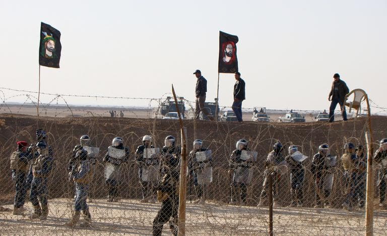 Iraqi police stand guard outside Camp Ashraf in northeast Baghdad, Iraq. (AP/People's Mujahedeen Organization of Iraq)