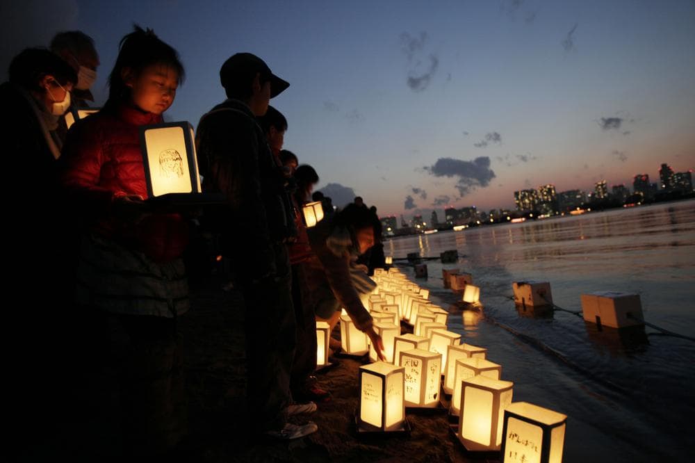 A girl waits her turn to release a lantern into the waters of Tokyo Bay to mark the anniversary of the earthquake and tsunami. (AP)