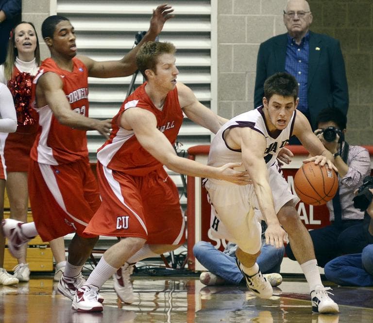 Harvard&#039;s Oliver McNally, right, escapes the defensive tactics of Cornell&#039;s Chris Wroblewski, center, and Johnathan Gray during a game March 3, 2012. (AP)