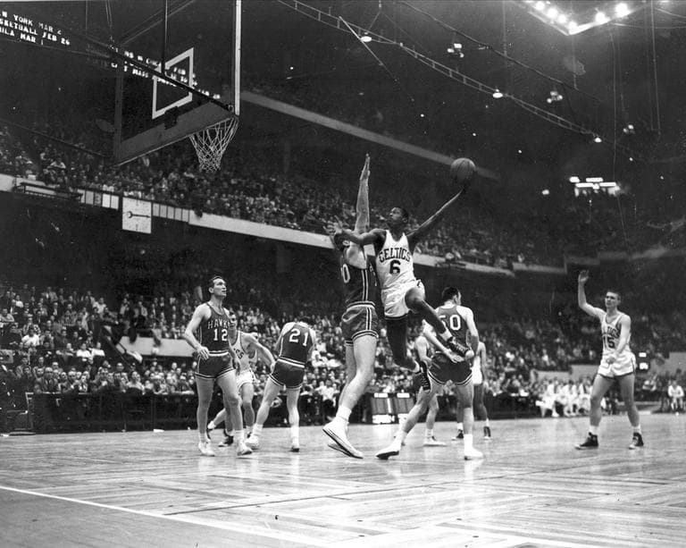 Bill Russell (6) Boston Celtics, goes up against defense Charlie Share (70), St. Louis Hawks,  at Boston Garden, Feb. 1951. Behind Russell is Hawks' Ed Macauley (50). Boston won 125-112 in second game of double header. (AP Photo)