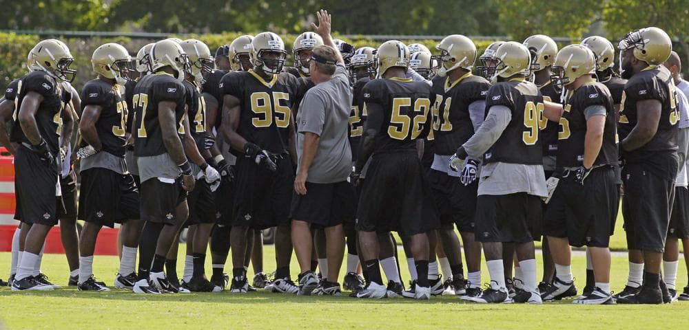 Gregg Williams (center) meets with his defense during the preseason in 2011. Was the issue of &quot;bounty hunting&quot; brought up then? (AP)