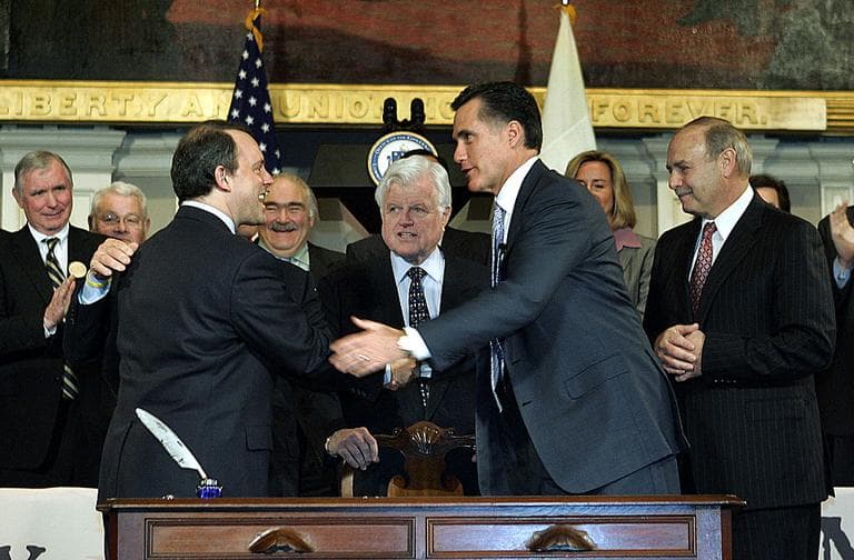 The health care reform effort passed into law in Massachusetts in 2006 helped expand coverage in the state, yet costs continue to rise. Above, former Mass. Gov. Mitt Romney signs health care reform into law. (AP)