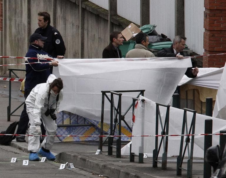Police officers gather evidence at the site of a shooting in Toulouse, southwestern France, Monday, March 19. (AP)