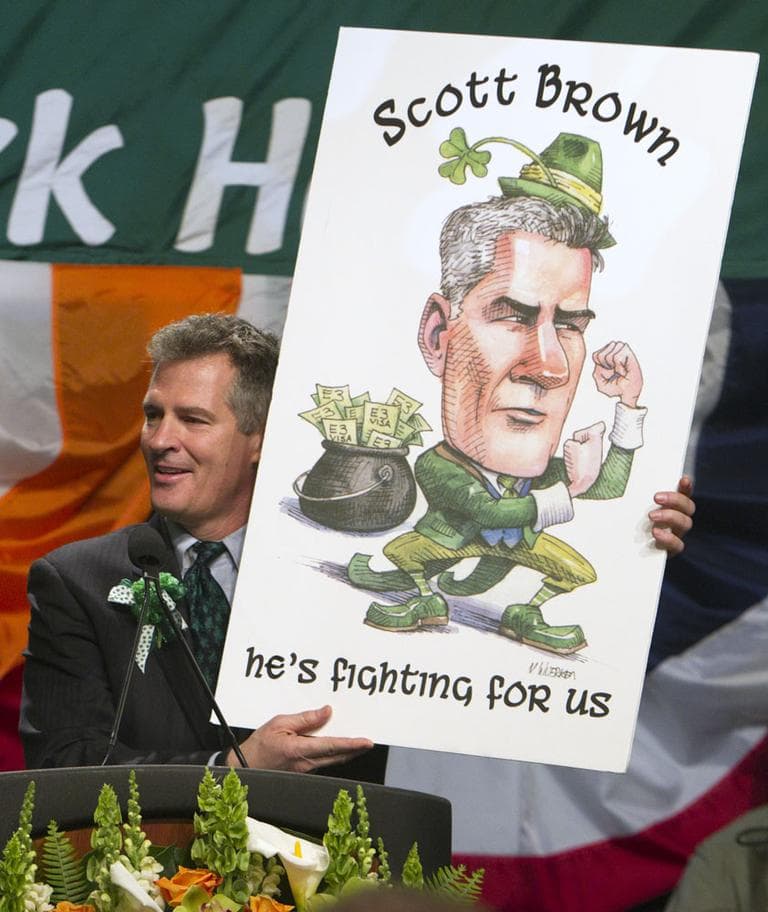 Sen. Scott Brown holds up a poster of himself while speaking at the annual St. Patrick's Day Breakfast in Boston, Sunday, March 18. (AP)