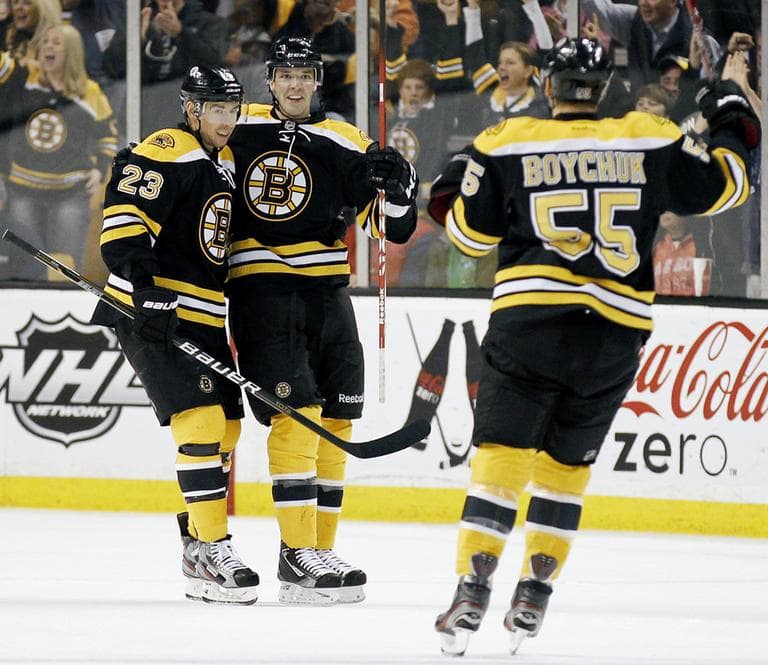 Boston Bruins&#039; Benoit Pouliot, center, is congratulated after his goal during the first period of their 8-0 win over the Toronto Maple Leafs in an NHL hockey game in Boston, Monday. (AP)