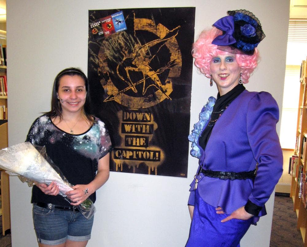 Bristol Eastern High School librarian Janet Kenney(right), dressed as the Hunger Games character, Effie Trinkett, as she presented eleventh grader, Chantel, with roses for winning the school's Hunger Games reenactment. (Brisol Eastern High School)