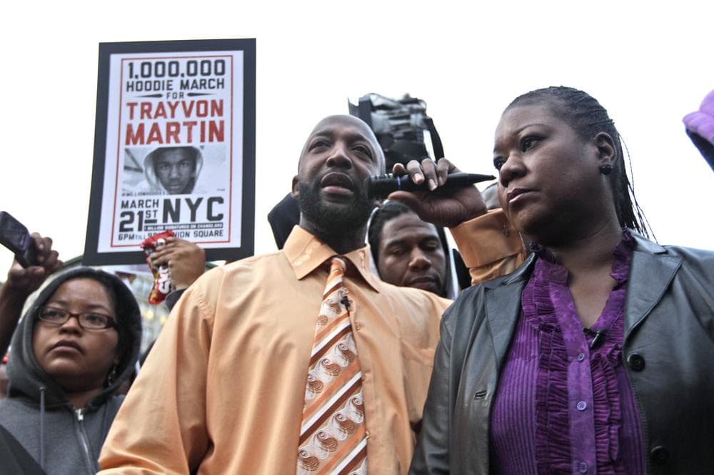 Trayvon Martin's parent's Tracy Martin, center, and Sybrina Fulton, right, take part in the Million Hoodie March in Union Square Wednesday night in New York. (AP)