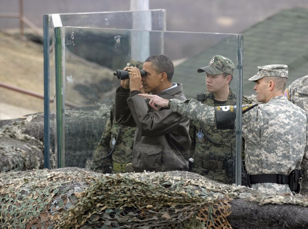 President Barack Obama looks through binoculars to see North Korea from Observation Post Ouellette in the Demilitarized Zone. (AP)