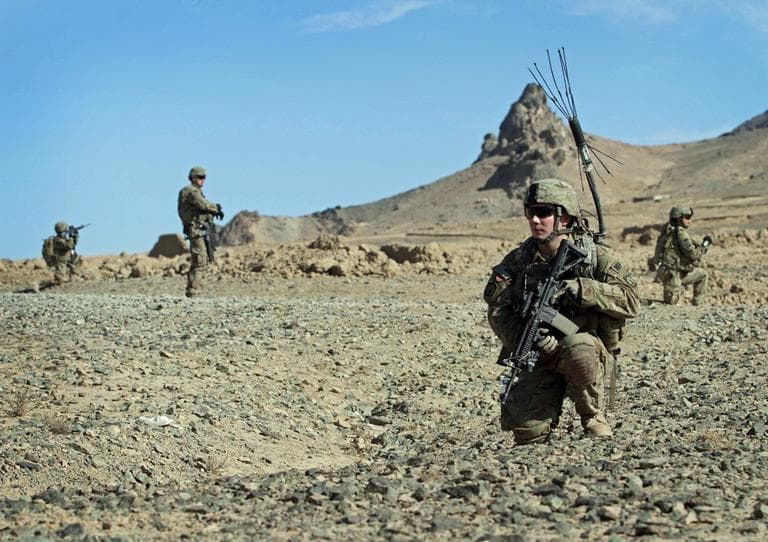 U.S. soldiers with the NATO- led International Security Assistance Force (ISAF) kneel on the ground, as they control the area during a foot patrol in Kandahar, south of Kabul, Afghanistan, Saturday, Jan. 7, 2012.  (AP)