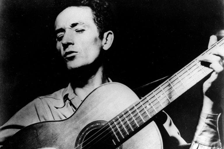 This undated file photo shows folk singer Woody Guthrie playing his guitar and singing.  (AP)