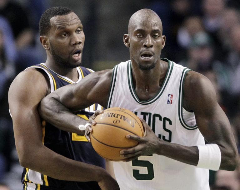 Utah Jazz center Al Jefferson reacts as Boston Celtics forward Kevin Garnett  jabs him with an elbow in the second half in Boston, Wednesday. (AP)