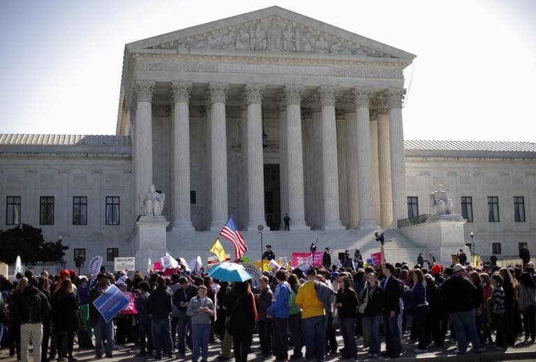 Supporters and opponents of health care reform rally in front of the Supreme Court in Washington. (AP)