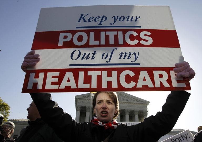 Amy Brighton from Medina, Ohio, who opposes health care reform, rallies in front of the Supreme Court in Washington, Tuesday, March 27, 2012, as the court continues arguments on the health care law signed by President Barack Obama. (AP)