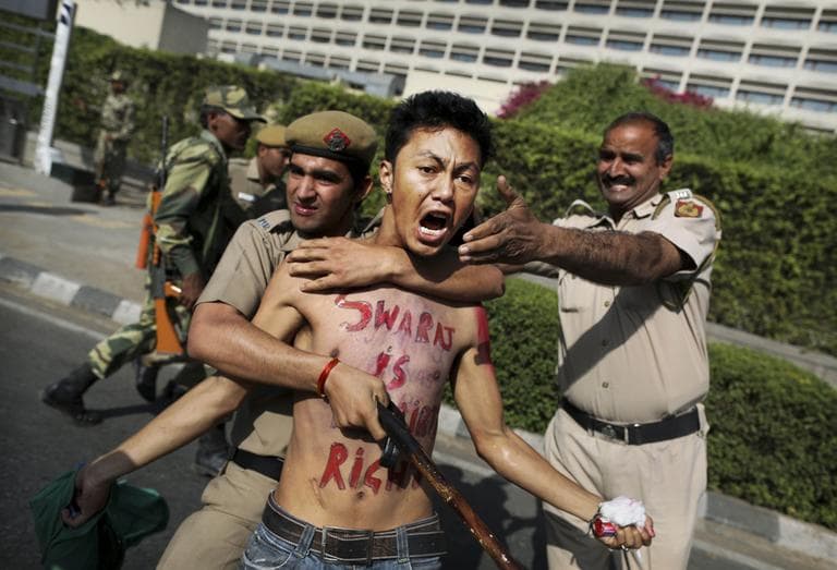 Indian police detain a Tibetan protester during a demonstration against the visit of Chinese President Hu Jintao outside his hotel in New Delhi, India, Friday, March 30. (AP)