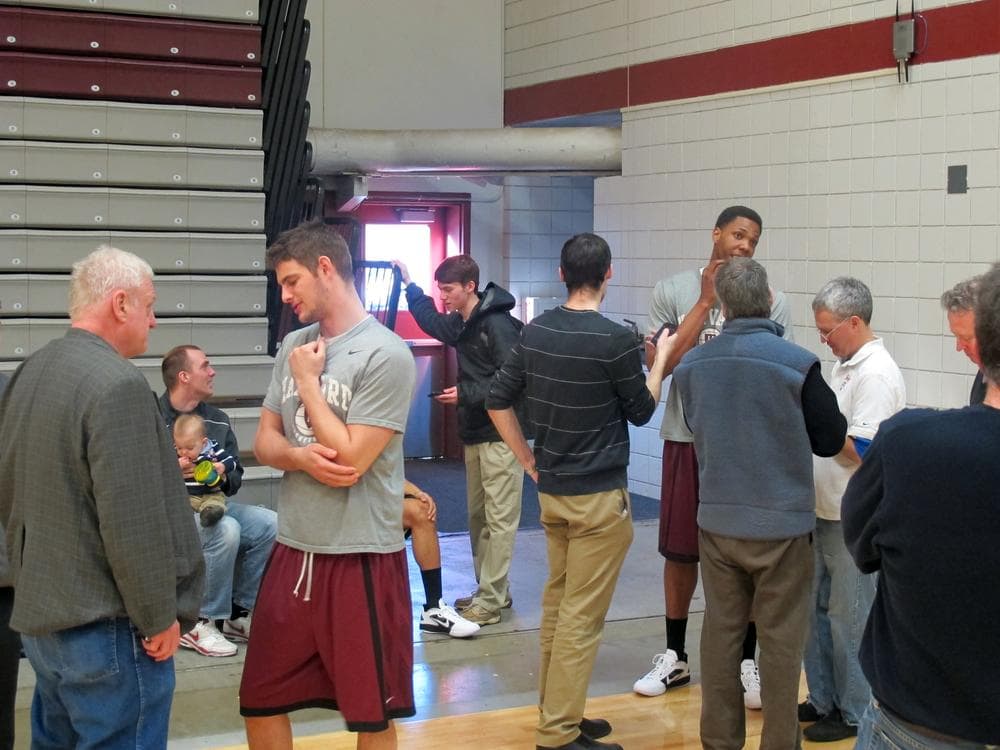 Harvard players Oliver McNally (left) and Keith Wright (background, right) speak to a small turnout of reporter after making the NCAA tournament for the first time in more than 6 decades. (Doug Tribou/NPR&#039;s Only A Game)