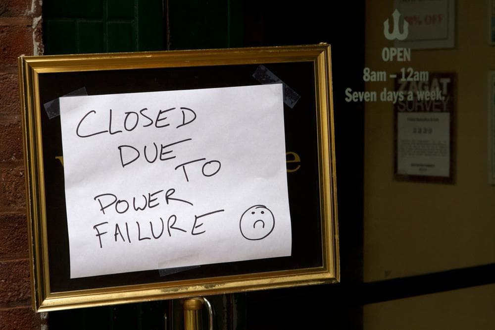 Closed sign in the window of Trident Booksellers and Cafe on Newbury Street. (Jesse Costa/WBUR)