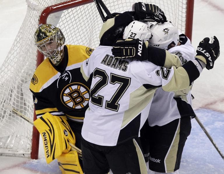 Boston Bruins goalie Marty Turco watches as Pittsburgh Penguins players celebrate after right wing Arron Asham&#039;s goal during the third period Tuesday. (AP)