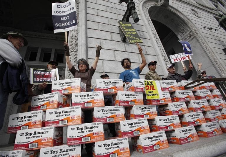 A union of California community college teachers protest tution fee hikes with cases of Ramen packages in front of California Gov. Jerry Brown's office in San Francisco, in March, 2011.  (AP / Paul Sakuma)