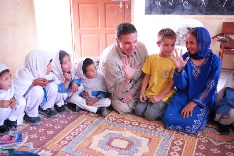 Greg Mortenson, his son Khyber, and daughter, Amira Mortenson, with students at Gultori War refugee school, Bromolo Colony, Karakoram mountains.  (PRNewsFoto/Central Asia Institute, Deirdre Eitel)