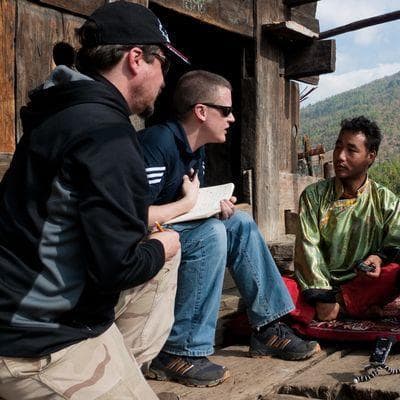 Greg Anderson and David Harrison interview Dorji Khandu Thongdok and Lamu Norbu in Thungri village, West Kameng District, Arunachal Pradesh. (Photo Jeremy Fahringer, Courtesy National Geographic)