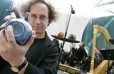 Tod Machover poses with a Beatbug, a percussive instrument that allows players to create rhythmic patterns, during a rehearsal of his Toy Symphony in New York City on May 17, 2003. (AP)