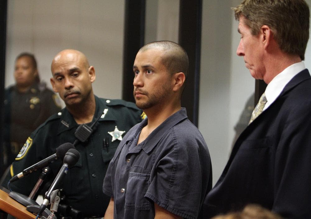 George Zimmerman, center, stands with a Seminole County Deputy  and his attorney Mark O'Mara during a court hearing Thursday in Sanford, Fla. (AP/Gary W. Green, Orlando Sentinel, Pool)