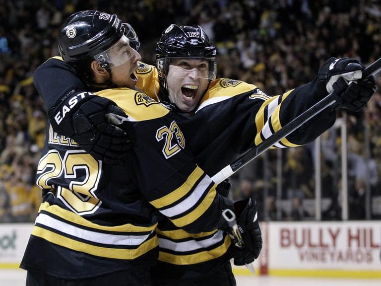Boston Bruins center Chris Kelly celebrates his game-winning goal with left wing Brian Rolston as the Bruins beat the Washington Capitals 1-0 in overtime in Game 1. (AP)