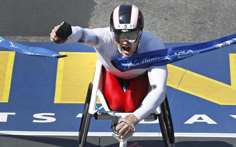Joshua R. Cassidy, of Canada, pumps his fist and yells as he crosses the finish line to win the men&#039;s wheelchair division of the 116th Boston Marathon in Boston. (AP)