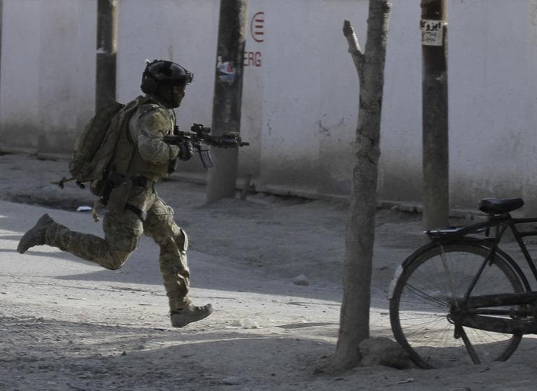 A NATO soldier runs to the scene of an attack in Kabul, Afghanistan, Sunday. (AP)