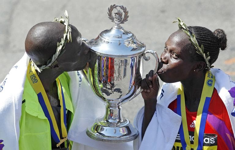 Wesley Korir, left, and Sharon Cherop, both of Kenya, kiss the winner&#039;s trophy after winning the men&#039;s and women&#039;s divisions of the 116th Boston Marathon in Boston, Monday. (AP)