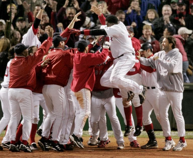 Boston Red Sox David Ortiz leaps into the waiting arms of his teammates as they celebrate his 12th inning game winning homer against the New York Yankees at Boston&#039;s Fenway Park in game four of the ALCS, Sunday Oct. 17, 2004. The Red Sox won, 6-4. (AP)