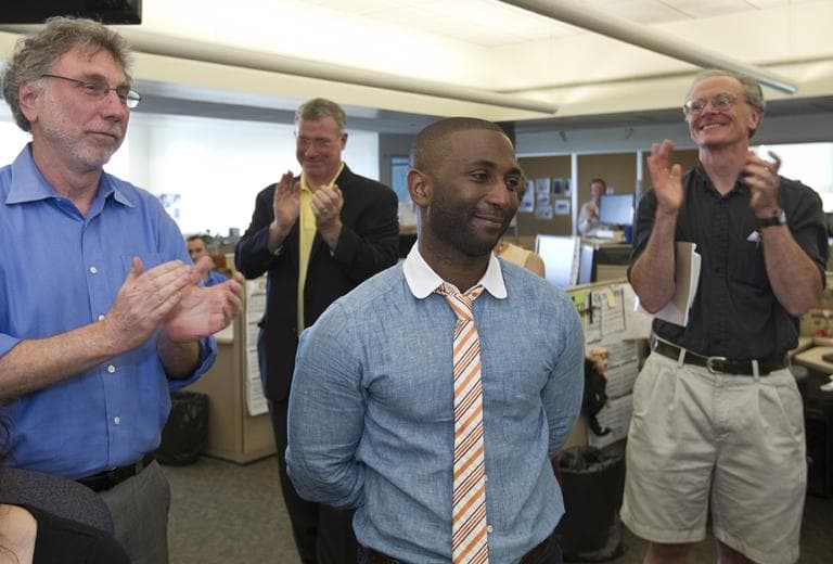 Wesley Morris, center, film critic for The Boston Globe, who was awarded the 2012 Pulitzer Prize for criticism, celebrates the announcement with his colleagues. (AP)