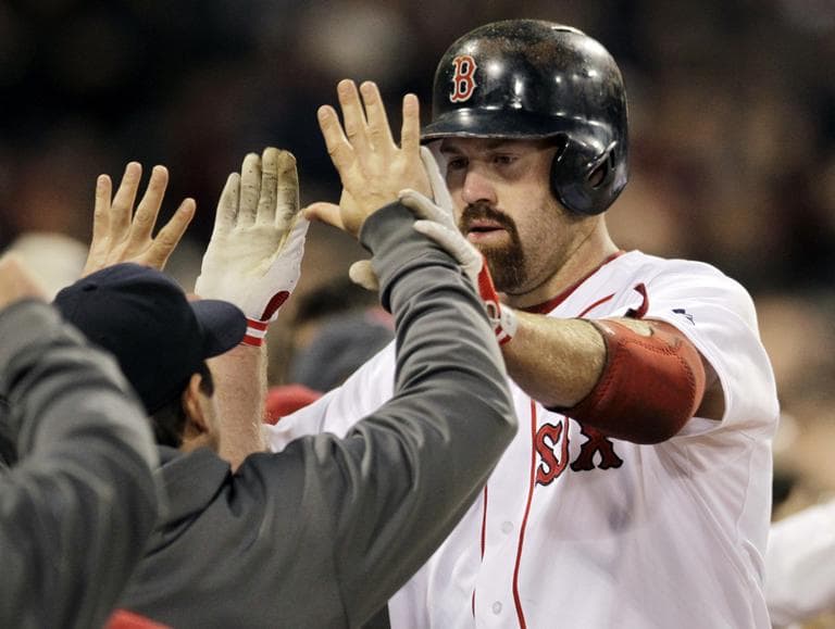 Boston Red Sox&#039;s Kevin Youkilis receives a high-five at the dugout after his two-run home run in the second inning, Wednesday. (AP)