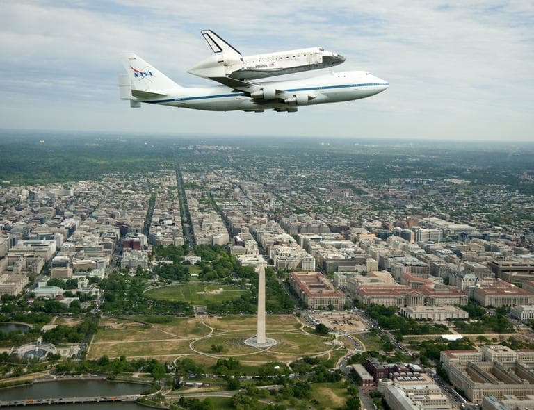 The Space shuttle Discovery, mounted atop a NASA 747 Shuttle Carrier Aircraft, flying over Washington skyline, including the Washington Monument, as seen from a NASA T-38 aircraft, Tuesday, April 17, 2012. Discovery, the longest-serving orbiter will be placed to its new home, the Smithsonian's National Air and Space Museum's Steven F. Udvar-Hazy Center in Chantilly, Va. (AP)