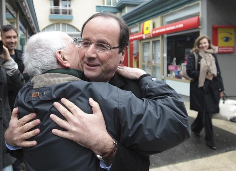 Socialist Party presidential candidate Francois Hollande hugs a supporter while leaving local party headquarters in Tulle, central France, Sunday, April 22, 2012. (AP)