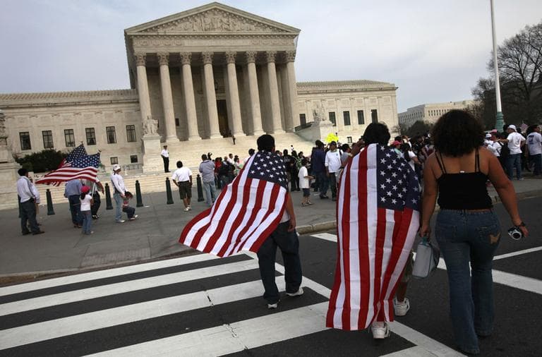 Immigration reform supporters walk past the Supreme Court during a rally for immigration reform in Washington, on Sunday, March 21, 2010.  (AP)