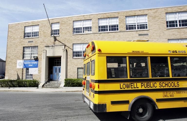 A Lowell public school bus passes the Immaculate Conception School in Lowell, Mass. in April, 2009. (AP)